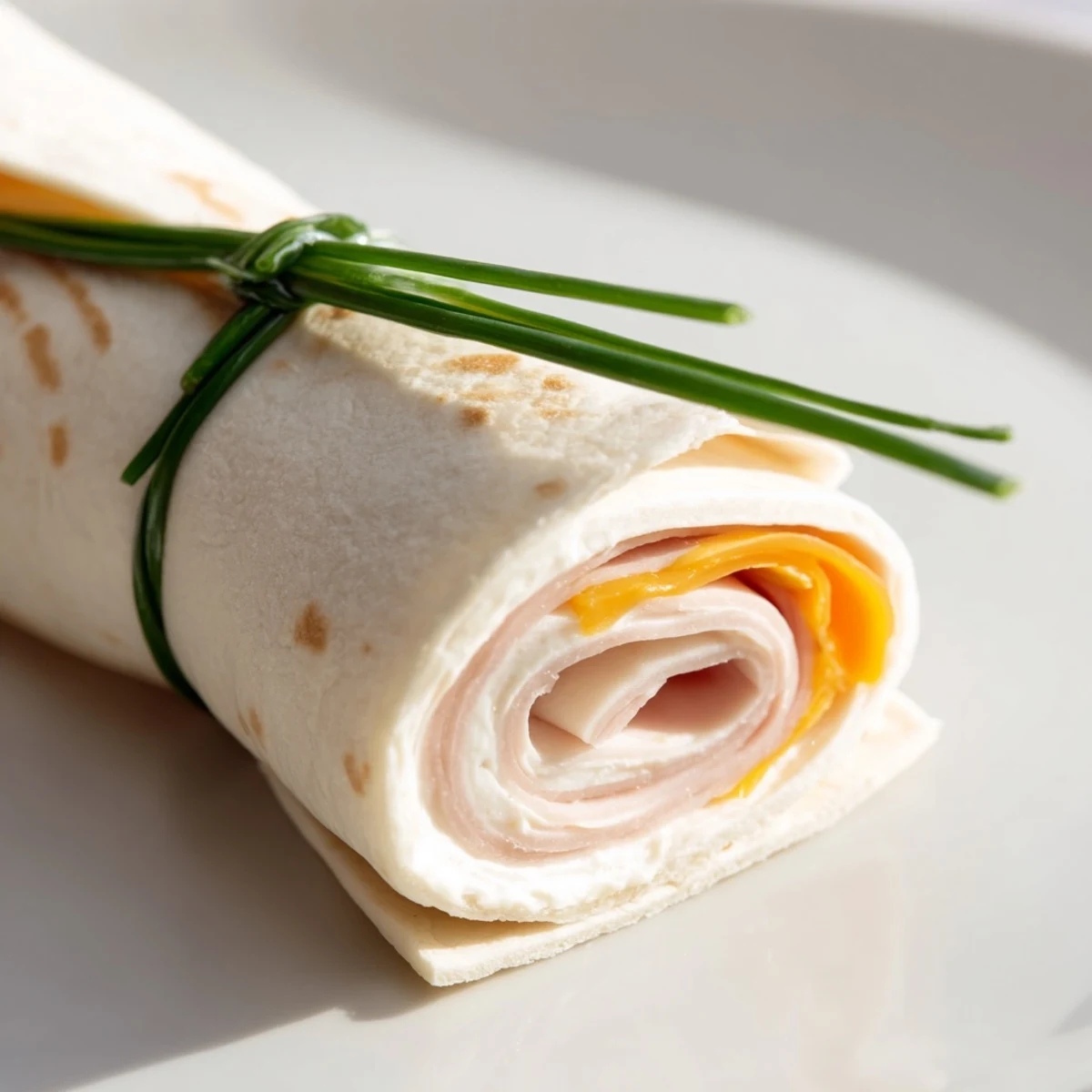 These cheesy Graduation Cap Diploma Snack Wraps are a perfect appetizer, showcasing rolled wraps with creative toppers.