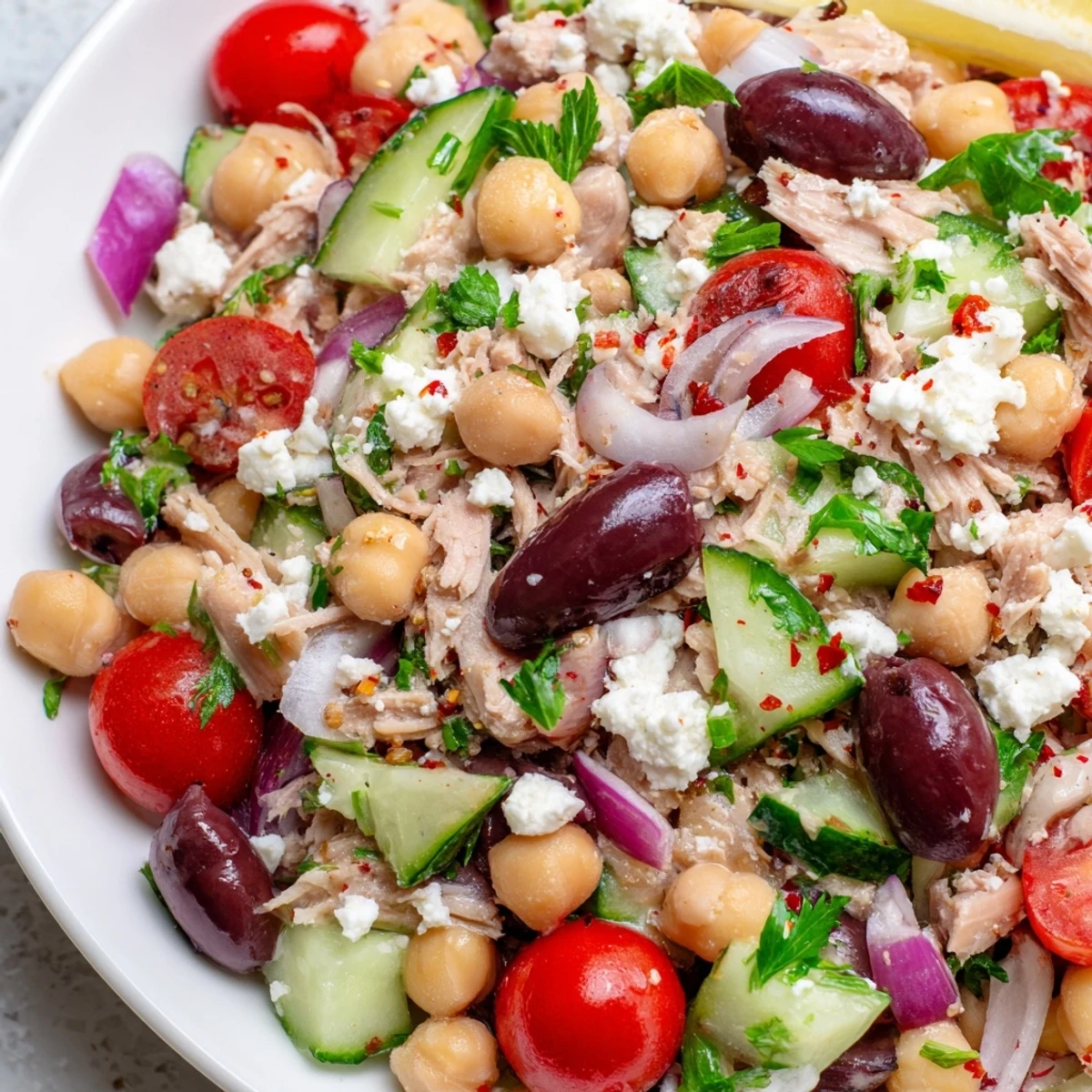 Golden-yellow Tuna Chickpea Salad, bursting with fresh cherry tomatoes, ready for a quick lunch.