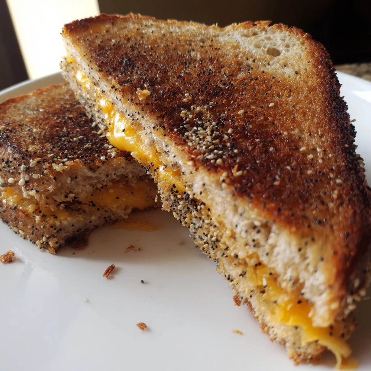 Crispy, seasoned bread surrounds gooey cheese in this delicious Everything Bagel Grilled Cheese, ready to eat.