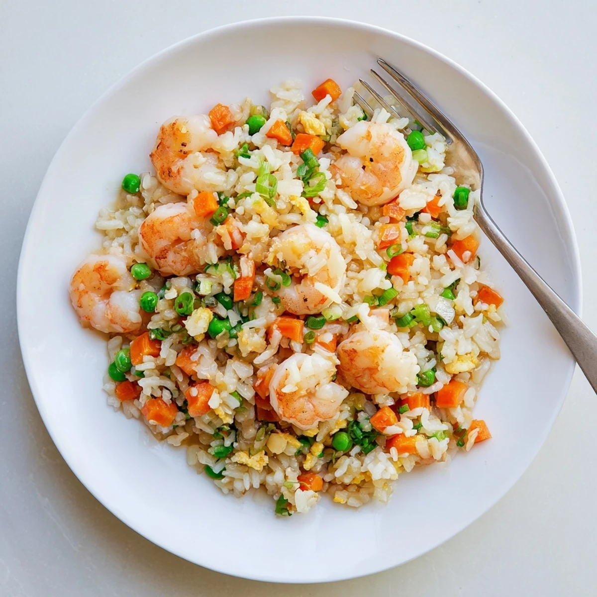 Steamed shrimp and fluffy jasmine rice are tossed with garlic and peas in this savory Shrimp Garlic Fried Rice.  