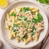 A steaming bowl of One-Pot Creamy Spinach & Turkey Christmas Pasta, perfect for a cozy holiday dinner.