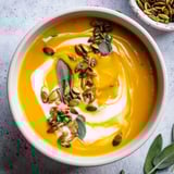 Golden butternut squash soup, perfectly seasoned with nutmeg and served steaming hot.