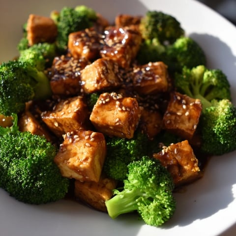 Crispy golden Sesame Tofu & Broccoli sheet pan dinner, ready to serve over fluffy rice with a savory sauce.
