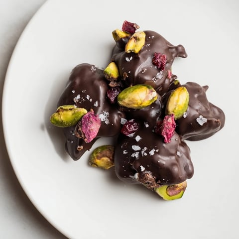 Pistachio and dried cranberry clusters: a close-up of beautifully arranged, bite-sized chocolate clusters.