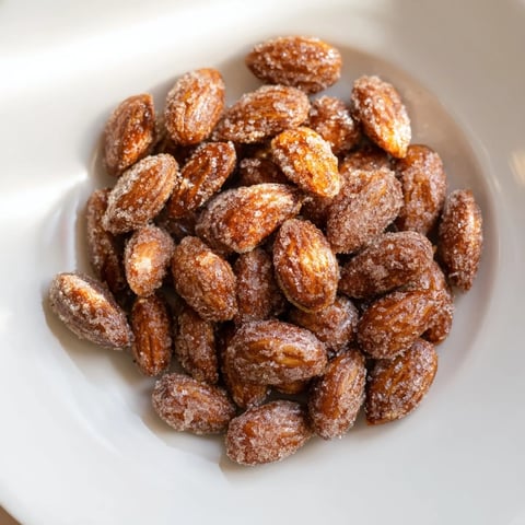 Golden, cinnamon-roasted almonds offer a sweet, crunchy bite, perfect for sharing as a snack.