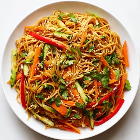 Vibrant Garlic Noodle Salad with colorful vegetables, coated in savory sauce, ready to serve.