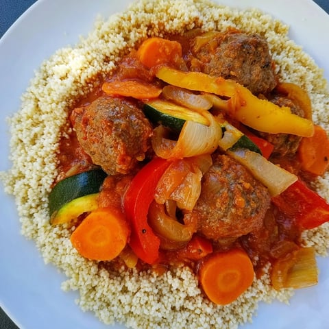 Vibrant North African Couscous Kefta, juicy meatballs in a rich sauce, served over fluffy couscous.