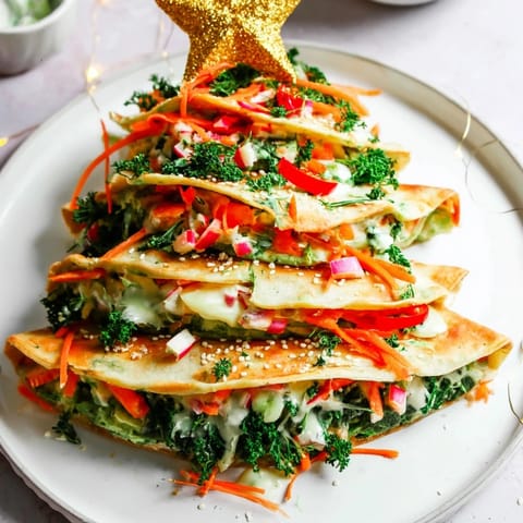 Crispy Air Fryer Christmas Tree Veggie Tortilla Wraps showcase colorful veggies, perfect for a festive appetizer.