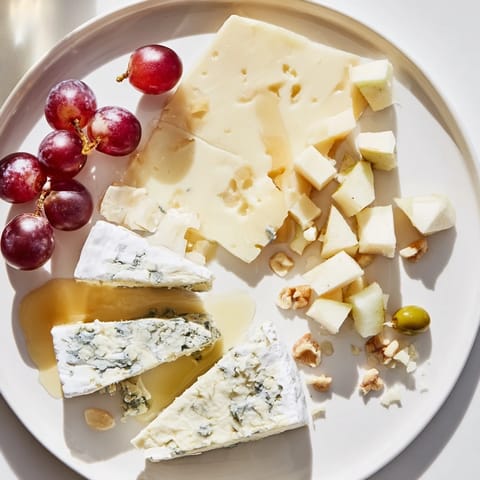 A stunning flat lay of Moonlight Picnic Board, showcasing assorted cheese, cured meats, and fresh fruits for sharing.