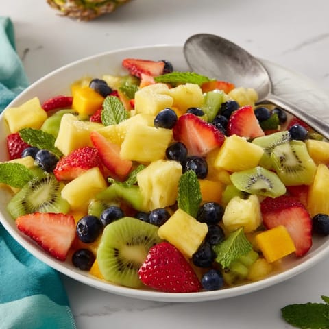 Vibrant tropical pineapple fruit boat, a delicious mix of fresh fruit perfect for a summer brunch display.