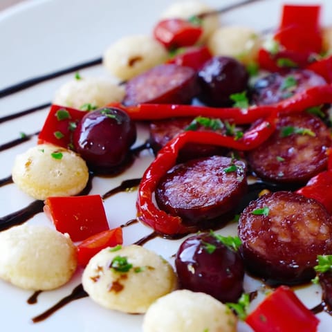 A beautiful Crimson Tide appetizer: vibrant red ingredients artfully swirling on white crackers, ready to eat.