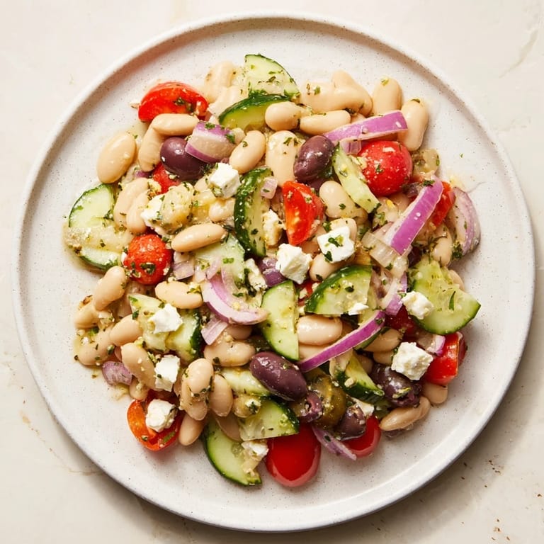 Fresh Mediterranean white bean salad with feta, bursting with bright tomatoes and zesty lemon dressing.