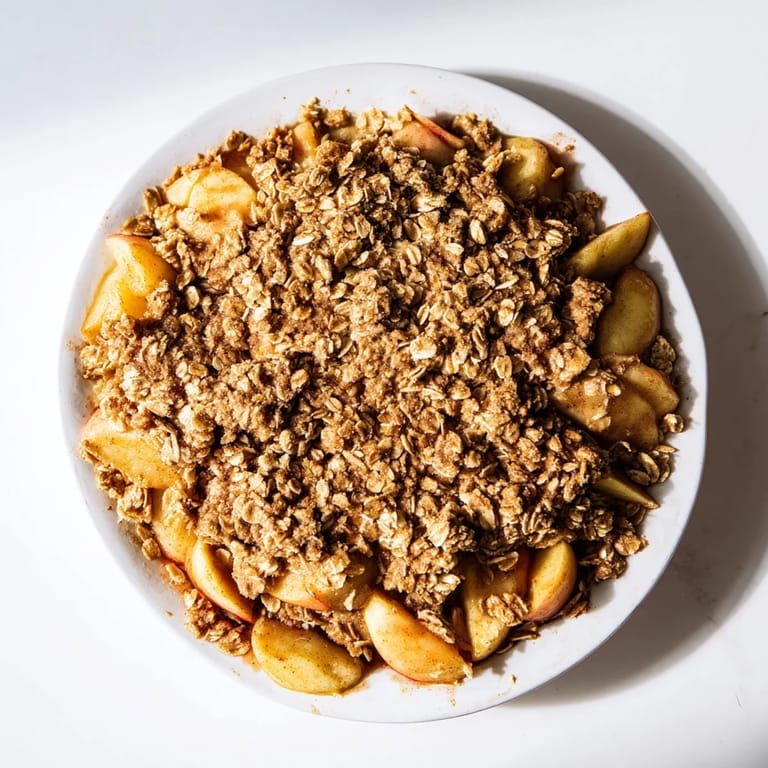 Golden brown topping covers tender baked apples in this delicious cinnamon oat apple crisp recipe.