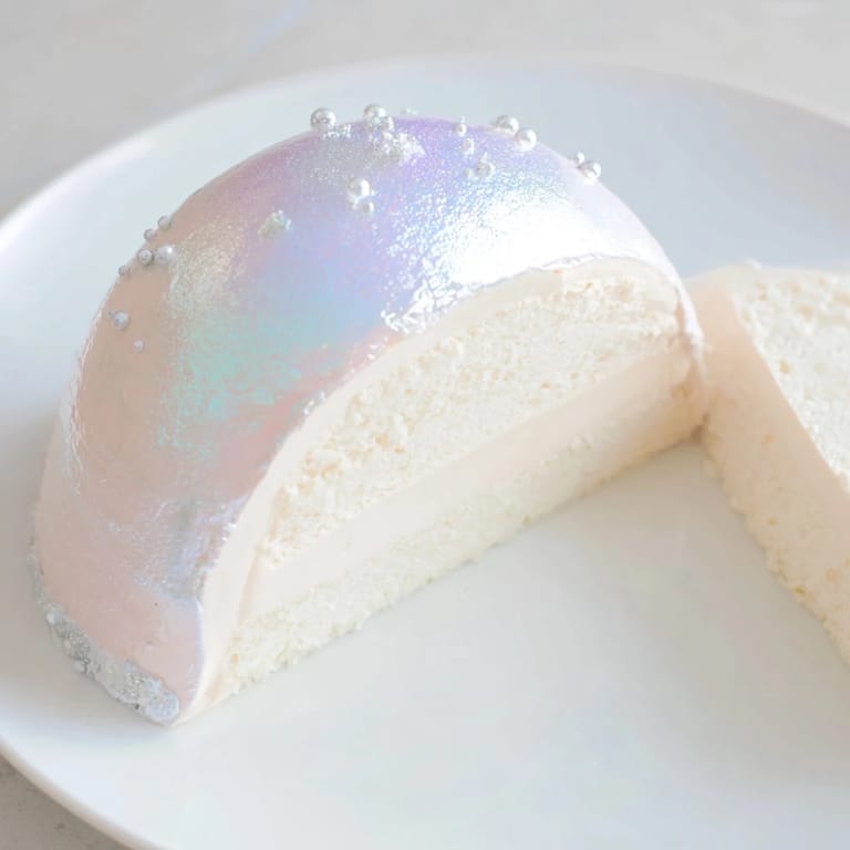 This dazzling Diamond Ring Engagement Cake is covered in a pearly white glaze with shimmering decorations.