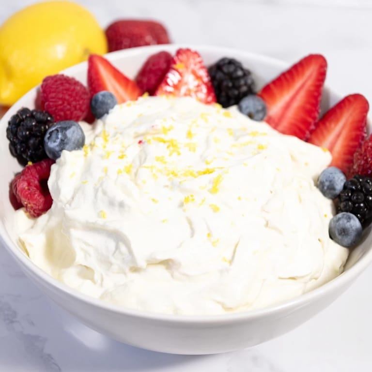 Enjoy this easy-to-make Fluffy Cream Cheese Fruit Dip, perfect to dip fresh berries in for dessert.
