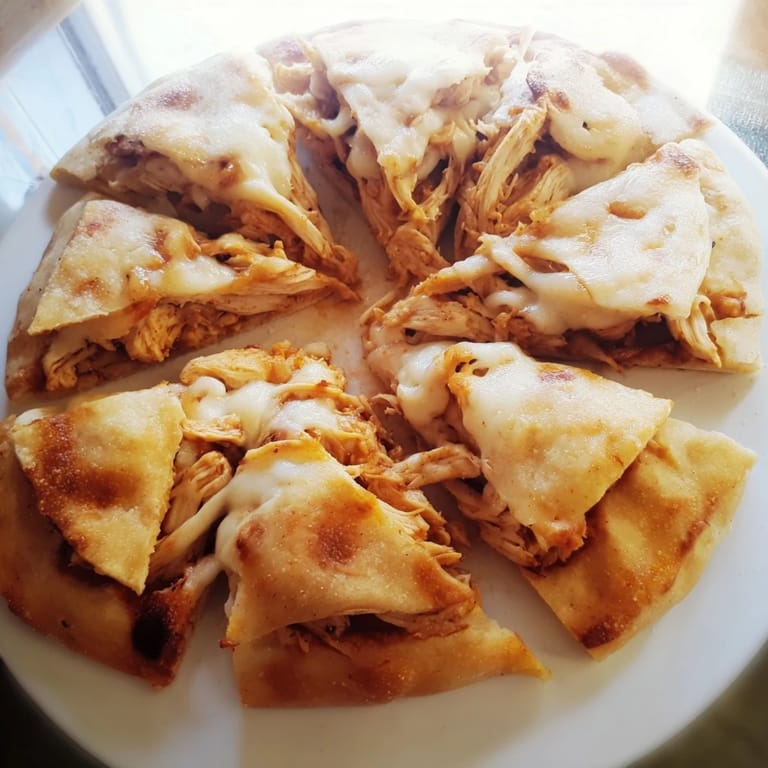 Golden-brown Leftover Pizza Grilled Cheese with shredded chicken, a satisfying quick snack or dinner.