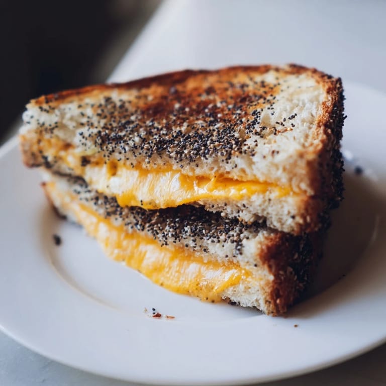 Enjoy a warm Everything Bagel Grilled Cheese, a flavorful and easy-to-make vegetarian meal.