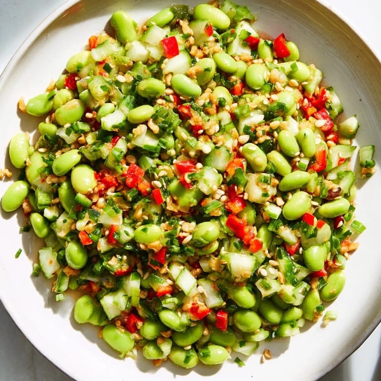This delicious edamame salad features colorful vegetables and a zesty sesame dressing.