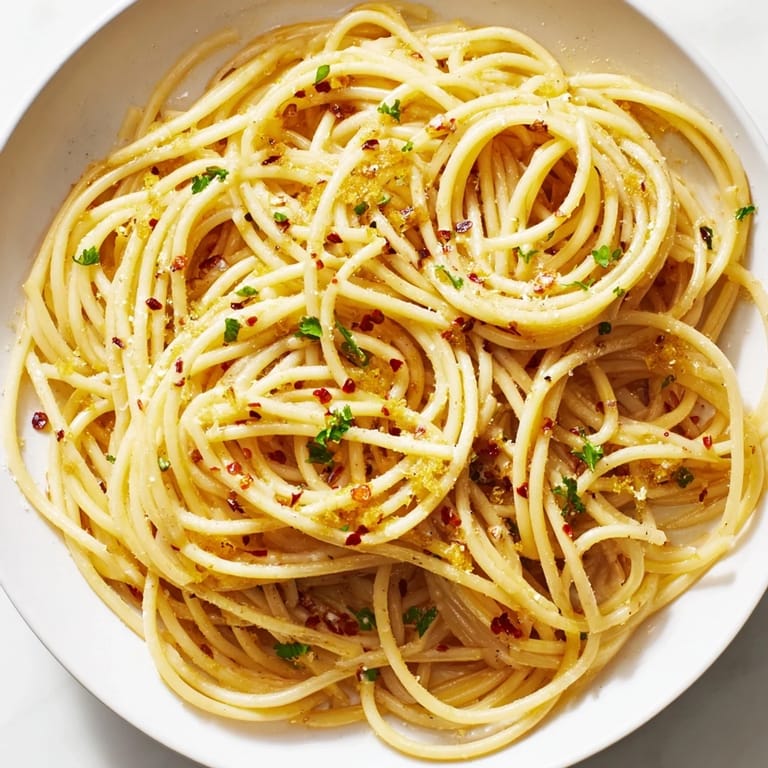 This image shows a beautifully plated Aglio e Olio, a simple, flavorful Italian pasta dish ready in minutes.